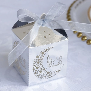 Detailed laser-cut silver gift box with moon and mosque patterns and blue ribbon
