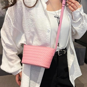 Pink woven mini bucket bag detail showing PU leather texture and crossbody strap