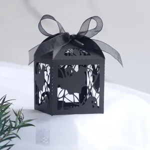 Detailed laser-cut Halloween treat box featuring spider web and ghost patterns with silk ribbon