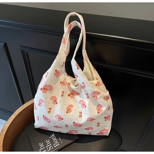 Detail of white canvas tote bag with red koi fish print and Chinese calligraphy design