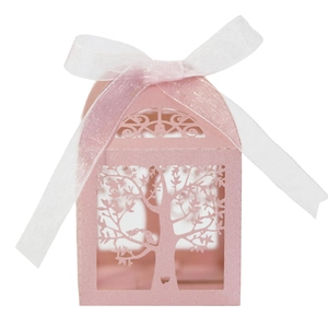 Detailed laser-cut tree and birds design on a pink candy box with white organza ribbon
