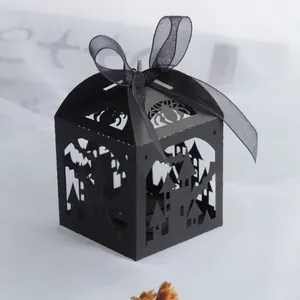 Close-up of Halloween laser-cut favor box with castle and bat patterns on black cardstock
