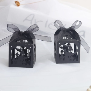 Two black hollow Halloween candy boxes with castle and bat patterns and organza bows