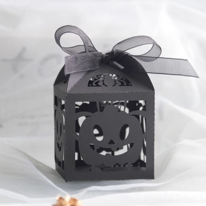 Detail of laser-cut black Halloween gift box with pumpkin and spider hollow patterns
