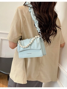 Light blue ruched cloud shoulder bag with pearl handle and minimalist flap design
