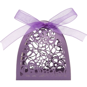 Detail of purple laser-cut flower candy box with elegant ribbon bow for wedding parties