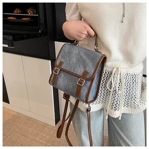Detail of the blue vintage backpack with brown leather straps and enjoy great time text