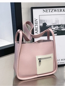 Pink litchi pattern leather bucket bag with contrasting white zip pocket and lock