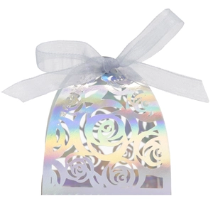 Detail showing laser-cut iridescent rose candy box with an elegant white silk ribbon bow