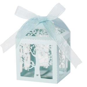 Detail view of light blue laser cut favor box with tree design and satin ribbon bow