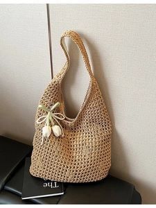 Handwoven straw tote bag with hollow patterns and a decorative tulip pearl charm