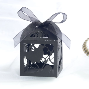 Hollow laser-cut Halloween candy box with ghost and spider web design and black ribbon