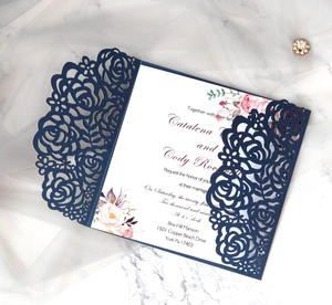 Detail of laser-cut rose hollow wedding invitation with elegant floral inner card