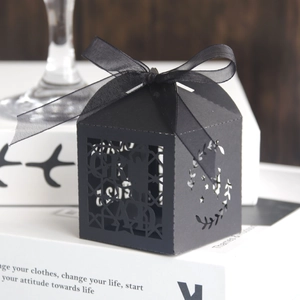 Elegant black laser-cut graduation favor box with 'GRAD' text and a black silk ribbon