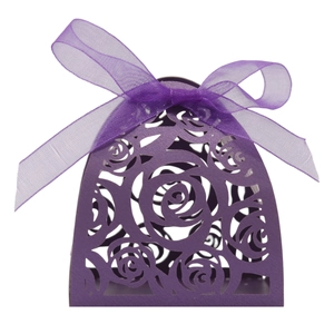Detail of purple laser-cut paper gift box featuring intricate rose patterns and ribbon