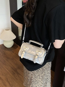 Silver metallic mini crossbody handbag with top handle and adjustable shoulder strap