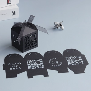 Detail of Class of 2025 black hollow laser-cut graduation party favors candy boxes