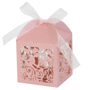 Detail of pink laser-cut 18th birthday candy box with floral patterns and white ribbon