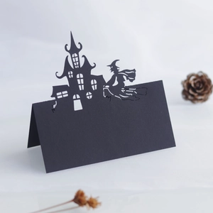 Laser-cut Halloween place card featuring a black gothic castle and flying witch silhouette