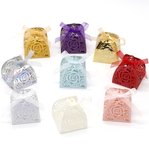 Macro view of laser-cut rose hollow favor boxes in various metallic reflective colors