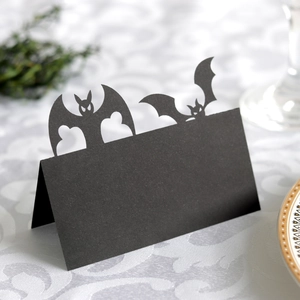 Halloween bat place cards made of black hollowed paper for festive party table settings