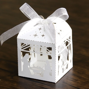 Detailed laser-cut nativity scene candy box in pearl white with elegant ribbon bow