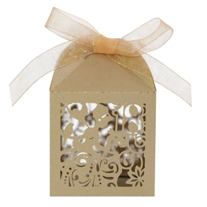 Detail of laser-cut number 18 candy box with floral patterns and a gold ribbon bow
