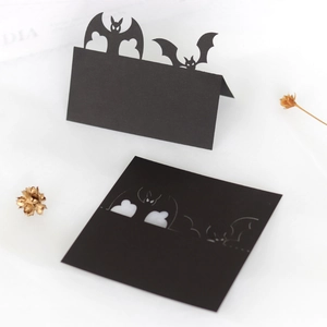 Halloween table place cards featuring intricate black 3D hollow bat design for party decor