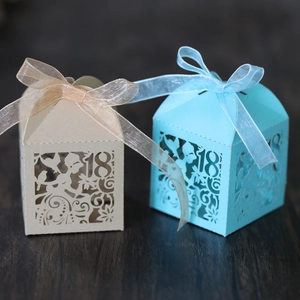 Detail showing laser cut number 18 hollow candy boxes with elegant organza ribbons