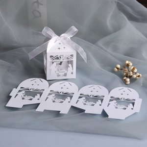 Pearl white nativity scene candy box with laser-cut design and white ribbon bow