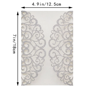 Detail of laser-cut ivory wedding invitation sleeve with silver glitter lace pattern