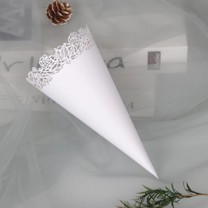 Close-up of white paper flower cone with delicate hollow lace edge for wedding celebrations