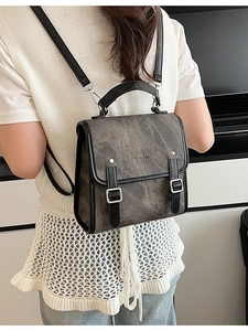 Vintage gray faux leather backpack for women with silver buckles and a retro aesthetic