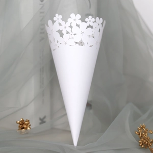 Detailed laser-cut white wedding petal cone with elegant hollow floral pattern and lace edge