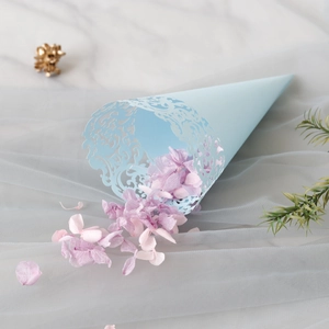 Close-up of light blue laser-cut hollow lace petal cone with dried hydrangea petals