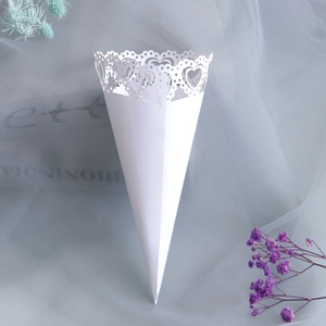 Detail of white laser-cut heart pattern paper flower cone for wedding confetti