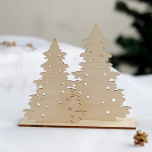 Laser-cut wooden Christmas tree jewelry stand for earring display on a white fabric base