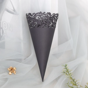 Close-up of black laser-cut lace pattern paper cone for wedding petals and confetti