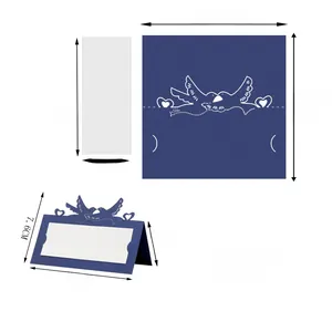 Detailed view of dark blue laser cut bird place card with heart motif and white inner paper
