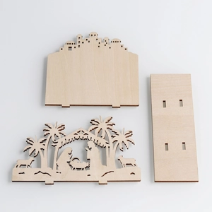 Laser cut wooden Nativity scene components featuring city skyline and palm tree detail