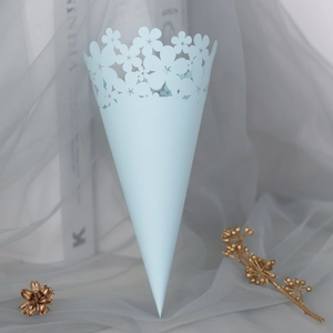 Detail of light blue laser-cut wedding petal cone with elegant lace flower patterns