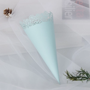 Close-up of light blue laser-cut rose lace paper cone for wedding petals and confetti