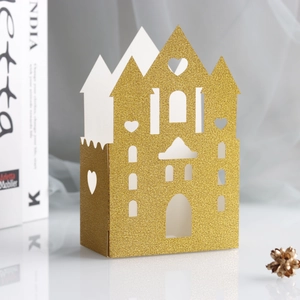 Champagne gold glitter castle favor box with intricate laser-cut hollow heart patterns