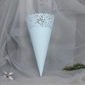 Detail of light blue laser-cut lace cone for wedding petals and confetti decor
