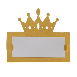 Detail of hollow golden crown place card holder with white insert card for wedding tables