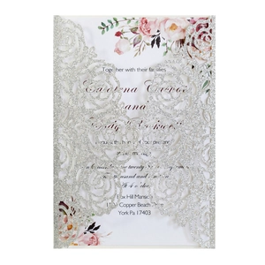 Detail of silver glitter laser cut rose wedding invitation with floral printed insert card