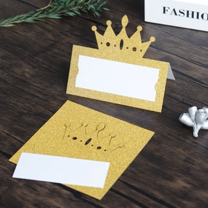 Detail of glitter gold crown place cards in folded and flat view for wedding table decor