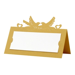 Golden laser-cut wedding place cards featuring love birds and heart-shaped hollow patterns
