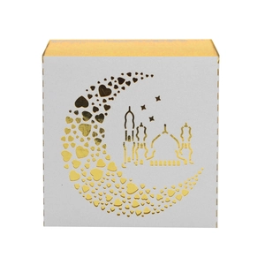Detail of white square gift box featuring gold foil moon silhouette and mosque pattern