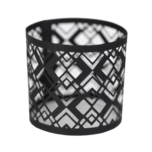 Detail of black laser-cut napkin ring with intricate geometric hollow patterns